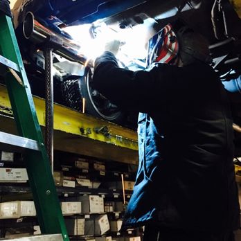 Mechanic performing professional muffler replacement in Denver, CO
