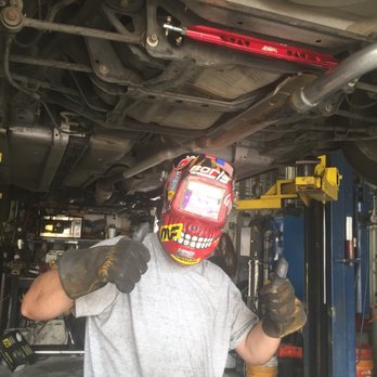 Mechanic performing radiator repair on a vehicle in Denver, CO